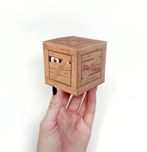 Close-up of Halloween candy box with wood grain texture and spooky red eyes design