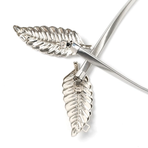 Detailed close-up of elastic silver metal waist belt featuring elegant double leaf buckle