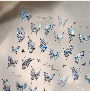 Macro shot of 3D aurora butterfly nail stickers with gold foil and laser effects