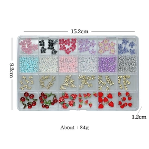 24 grids nail art set with resin flowers, pearls, and bows in a clear storage box