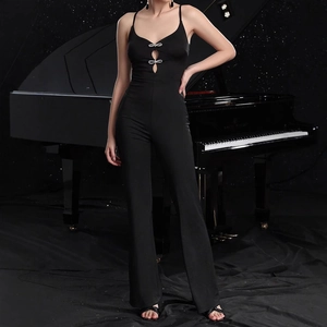 Detail of elegant black slim-fit jumpsuit featuring rhinestone bow accents and flared hem