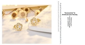 Close-up of gold hollow flower earrings with white zircon pave on white porcelain tray