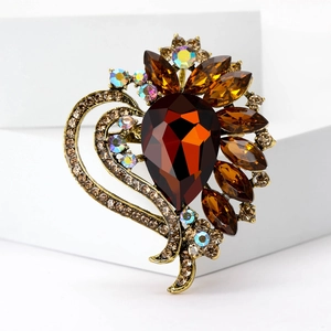 Vintage heart brooch featuring large amber water-drop gemstone and bronze crystals