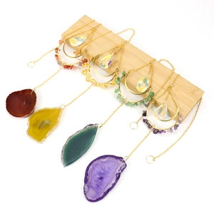 Natural agate moon crystal suncatcher set in colorful stones on wooden stand