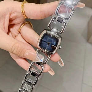 Close-up of elegant square silver bracelet watch with a minimalist navy blue dial