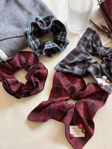 Detail of vintage red and blue plaid scrunchies with elegant ribbons and bead accents