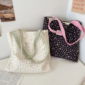 Detailed view of floral canvas tote bags with pleated texture and soft fabric handles