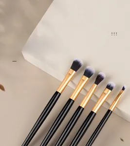 Detail of 5-piece dual-ended eyeshadow brush set with black handles and gold ferrules