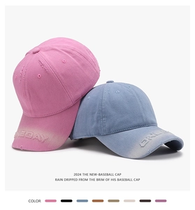 Close-up of washed cotton baseball caps with distressed brims and embroidery