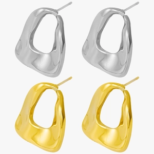 Detailed close-up showing gold and silver organic irregular oval metal stud earrings