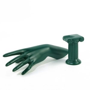 Macro detail of dark green matte resin hand model and jewelry display stand