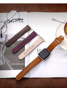 Selection of premium leather watch bands in brown, purple, and milk tea colors on a magazine