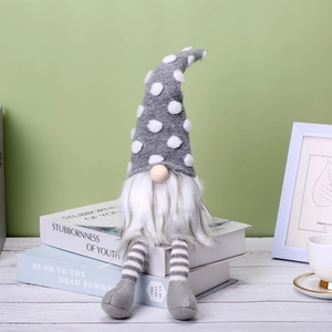 Nordic Christmas gnome with polka dot hat and striped legs sitting on books
