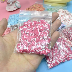 Macro shot of pink and white heart-shaped polymer clay slices in a transparent bag