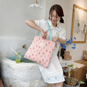 Detail of pink quilted canvas tote with bear prints and soraka beauté brand label