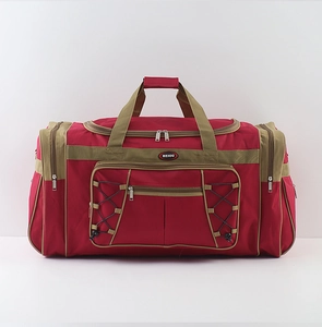 Detail of red travel bag featuring multiple front zip pockets and elastic mesh storage