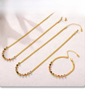 Detail of PVD gold plated snake chain jewelry set with colorful zircon stones