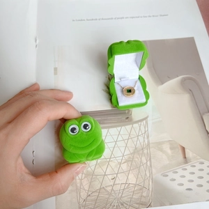 Green frog-shaped flocked jewelry box showing open and closed states with necklace