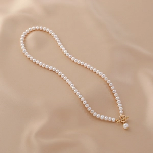 Elegant natural freshwater pearl necklace featuring a gold OT toggle clasp with small crystals