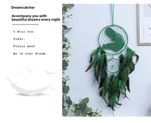 Detailed view of a green dinosaur dream catcher with feathers for nursery wall decoration