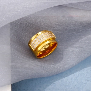 Detail of 18k gold plated spinning ring with three rows of white cubic zirconia