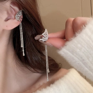 Close-up of butterfly ear cuff with long crystal tassels on a model's ear
