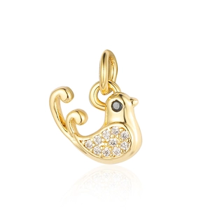 Detailed macro view of a gold bird pendant with sparkling white and black crystals