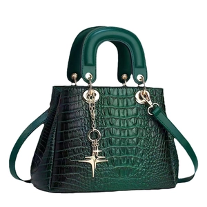 Elegant dark green crocodile pattern handbag with gold hardware and top handle design