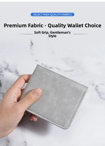 Detail of gray frosted leather men's bifold wallet with neat stitching in hand