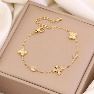 Elegant gold double-layer flower bracelet with pearls and crystals on a silk background
