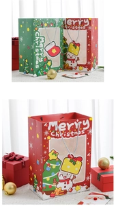 Detail of Christmas paper gift bags with transparent window and sturdy handles