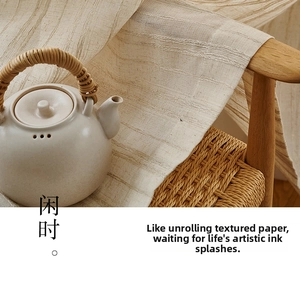 Macro detail of striped linen fabric texture draped on a wooden chair with a teapot