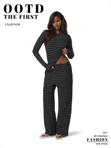 Detail of black and white striped knit loungewear set featuring soft ribbed texture fabric