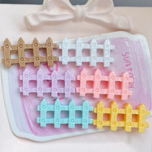 Glossy candy-colored resin fence charms for hair clips and DIY crafts in a pink tray