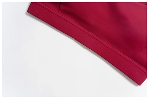 Detail of burgundy yoga bra featuring professional double-needle stitching and elastic hem