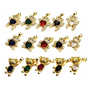 Detail of cute teddy bear pendants with zircon inlay and heart shaped colorful gemstones