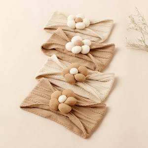 Set of four handmade nylon baby headbands with floral jacquard knit and soft texture