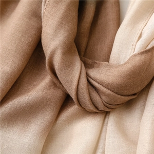 Detailed macro view of the soft gradient fabric texture with fine woven hem stitching
