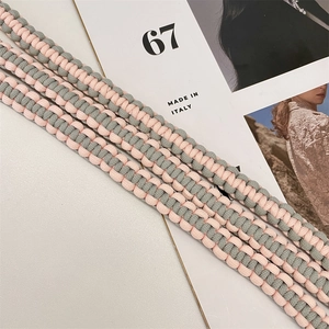 Detail of hand-woven adjustable shoulder straps in pink and sage green textured rope