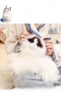 Close-up of realistic ragdoll cat plush toy with long soft fur and blue eyes detail