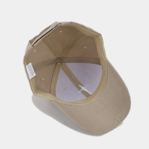 Detail showing the internal structure, 100% polyester fabric and stitching of the beige cap