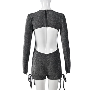 Detailed back view of sparkly metallic romper featuring open back and rear neck zipper