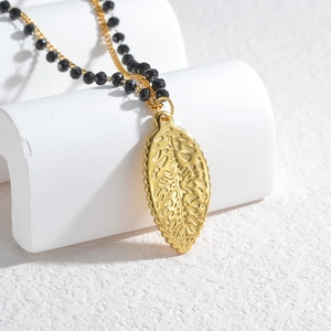 Double-layered 18K gold stainless steel necklace featuring black beads and starfish charm