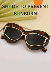 Close-up of tortoise shell cat eye sunglasses with gold metal frame detailing and Y2K aesthetic