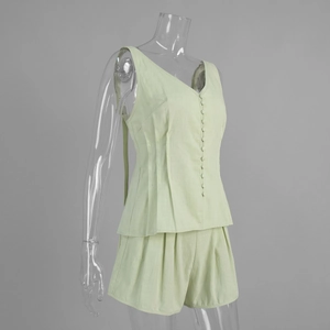 Detailed texture of mint green cotton set featuring pleated waist and buttoned vest