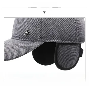 Detail of gray winter baseball cap showing ear flaps and fleece lining for wind protection