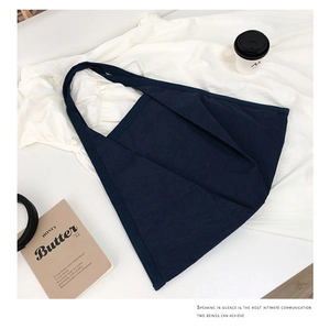Deep blue minimalist canvas tote bag with magazine and coffee cup on a white cloth