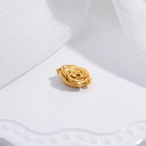 Elegant gold rose flower clasp for DIY jewelry making on a white textured background