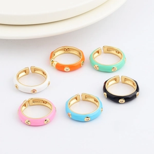Close-up of colorful enamel open rings with micro-set zircons in multiple vibrant colors