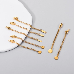 Detailed close-up of golden stainless steel extension chains with lobster clasps and tags